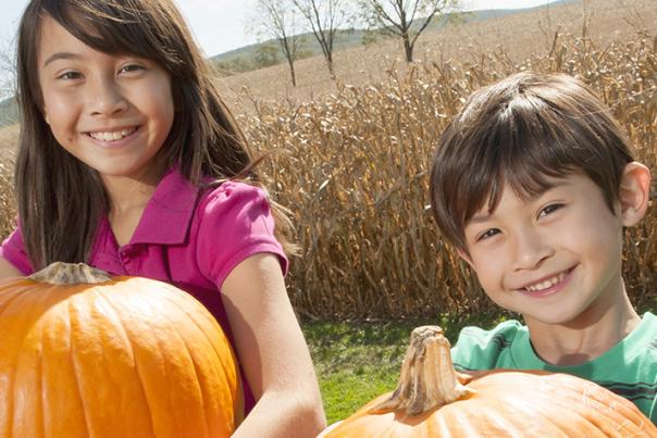 Children show off their perfect Halloween pumpkin picks at a Cumberland Valley pumpkin patch.