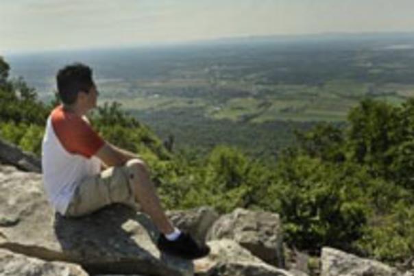 Man Sitting On Cliff Enjoying The View