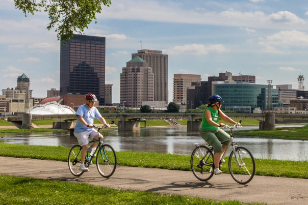 People riding bicycles along river