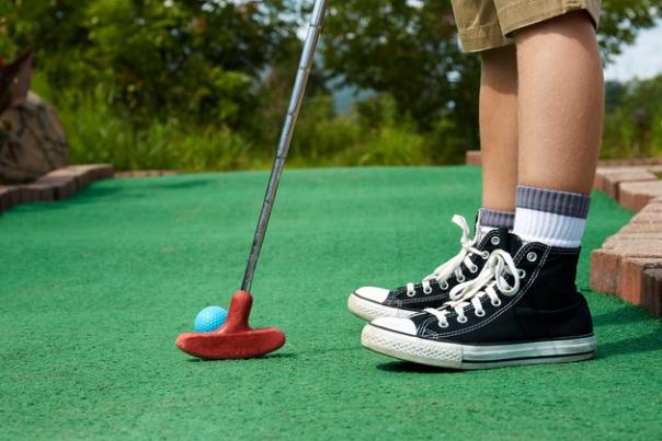 Person In Black And White Converses Putting A Golf Ball In Dayton, Ohio