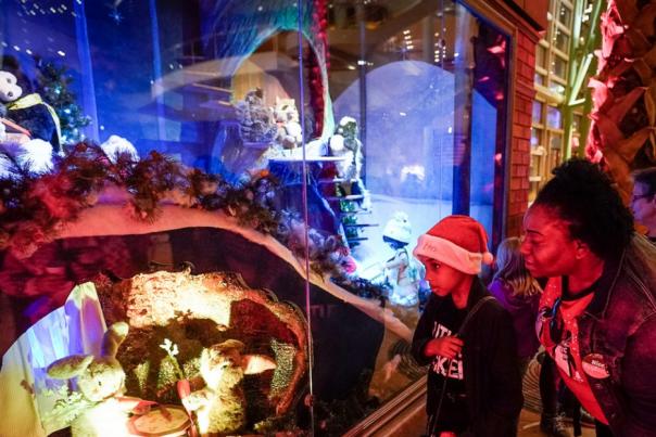 A woman and child viewing the Rike's Holiday Windows at the Schuster Center