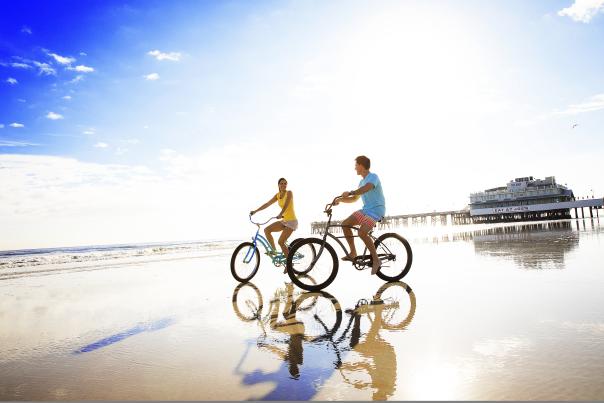 Couples on bikes on beach
