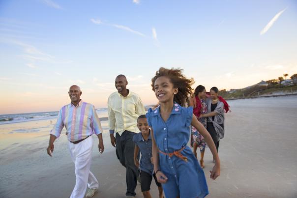 A family enjoys a stroll along Daytona Beach