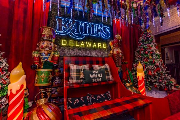 An image of The Sleigh Bar at Klondike Kate's featuring a sitting area decorated with candles, nutcrackers, holiday lights, and more.