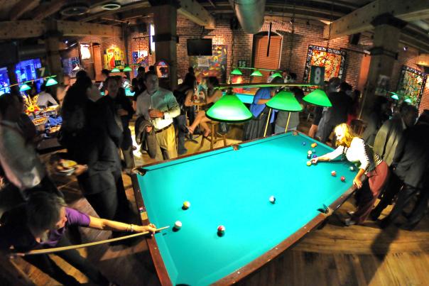 A group of people playing pool at Wynkoop Brewery.