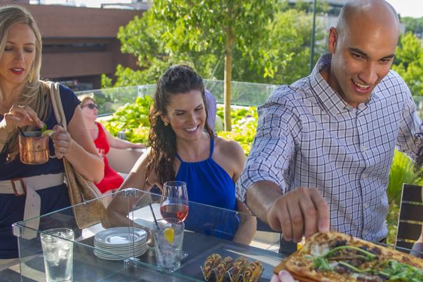A group of people enjoys a platter of food in Cherry Creek North.