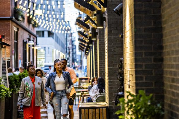 People walking through the Dairy Block alleyway in Denver, Colorado.