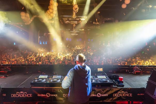 A DJ performs on a stage at Decadence in Denver