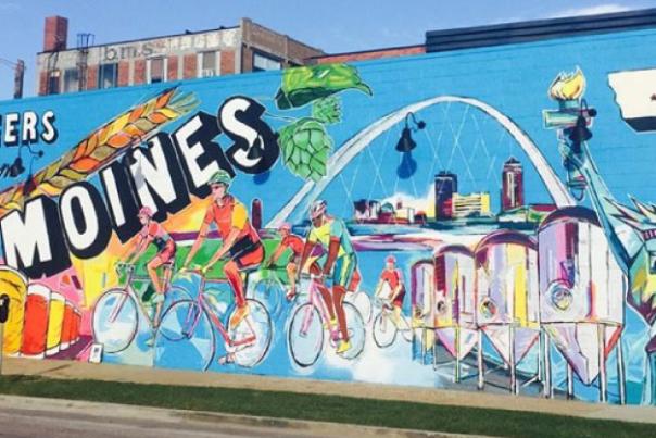 Large Exile Mural displaying "Cheers from Des Moines" with Des Moines highlights