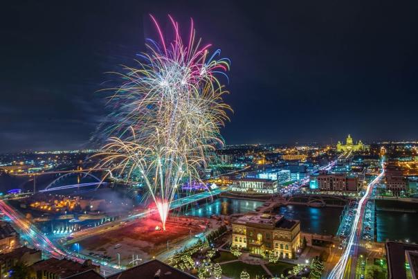 Aerial view of Downtown Des Moines with fireworks shooting off at night