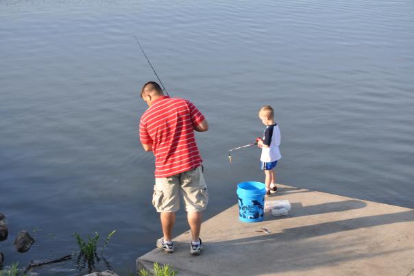 Father and Son fishing together off of a dock