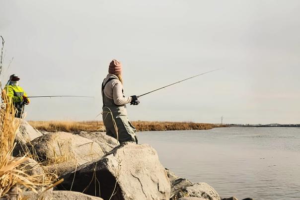 People fishing on the shoreline of Devils Lake, ND.