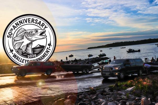 Boats going into the water at Devils Lake with the sun rising in the background