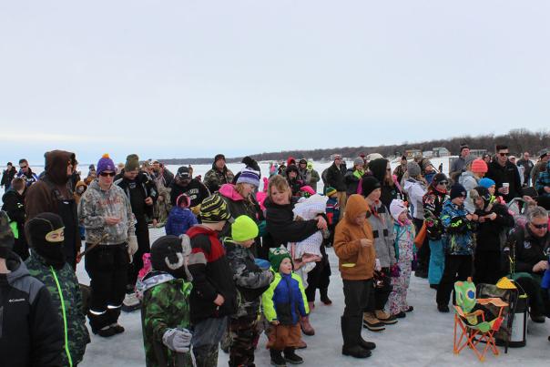 Parents and kids ice fishing on Devils Lake ND, Shiver Fest.