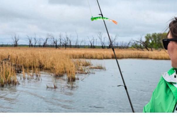 Girl fishing the shoreline on Devils Lake, North Dakota.