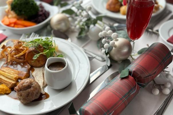 christmas dinner on a a plate and a christmas carcker
