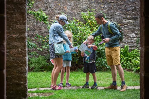 A family exploring the garden in summer at Compton Castle, Devon | James Dobson