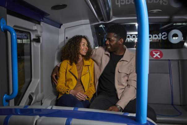 Two people on a stagecoach bus at night