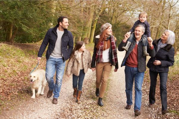 family walking a dog in autumn