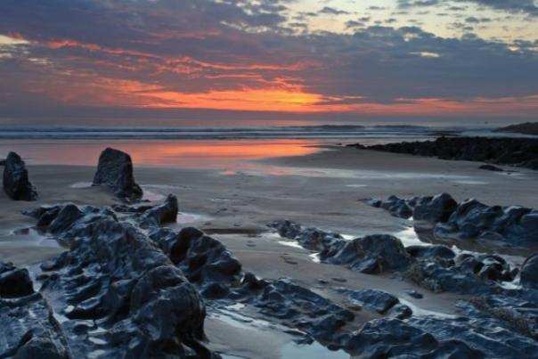 image shows beach at sunset