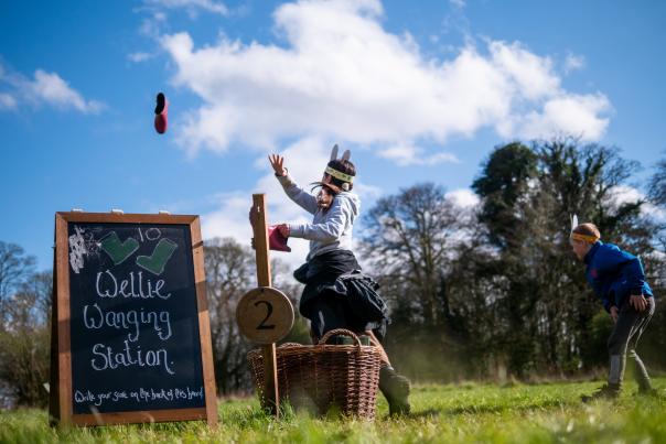 children on a sunny day tossing a welly