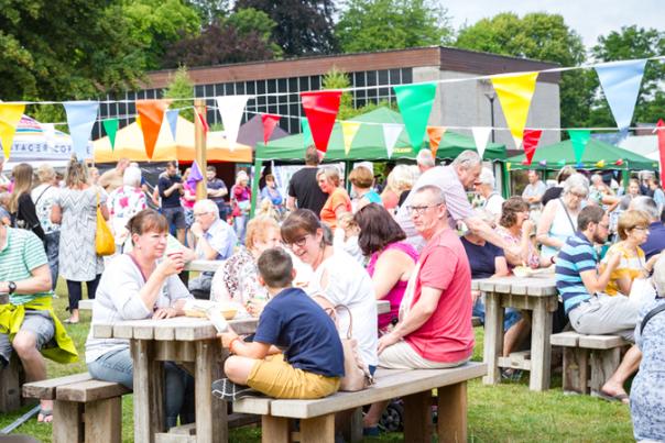 groups of people at buckfast abbey sitting on picnic tables