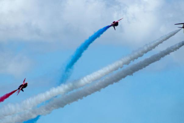 red arrows flying against blue skies