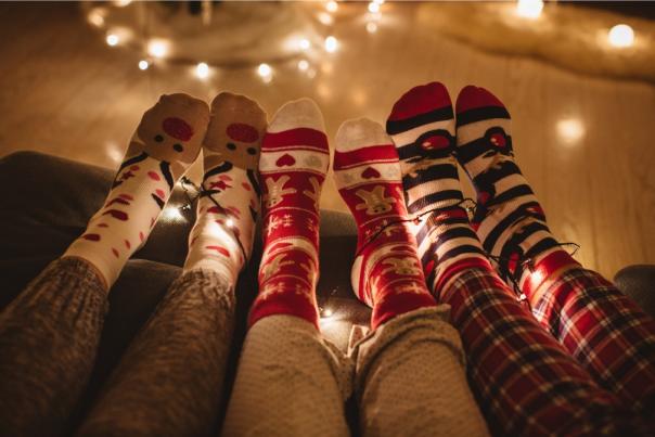 people wearing christmas socks looking cosy