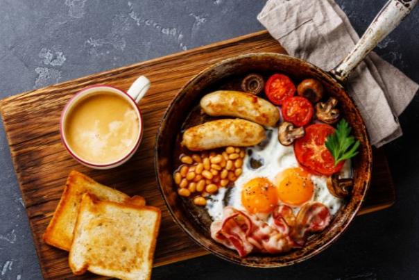 image shows a full english breakfast on a board