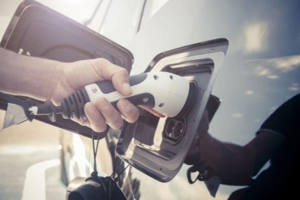 person charging electric car