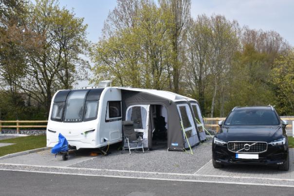 car next to a tent and caravan