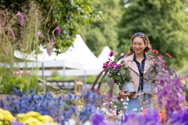 A person holding pots of flowers at the RHS floral show