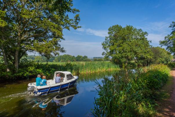 image shows a boat on a canal