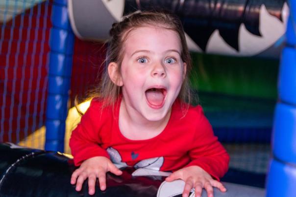 image shows a child in soft play