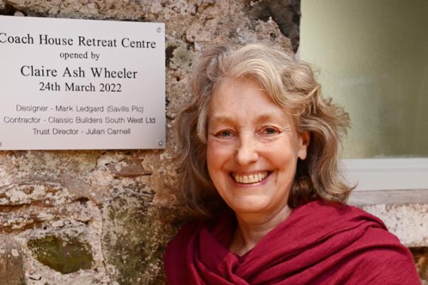 lady stood next to plaque
