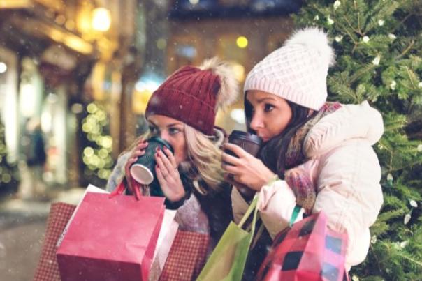 women drinking coffee while christmas shopping