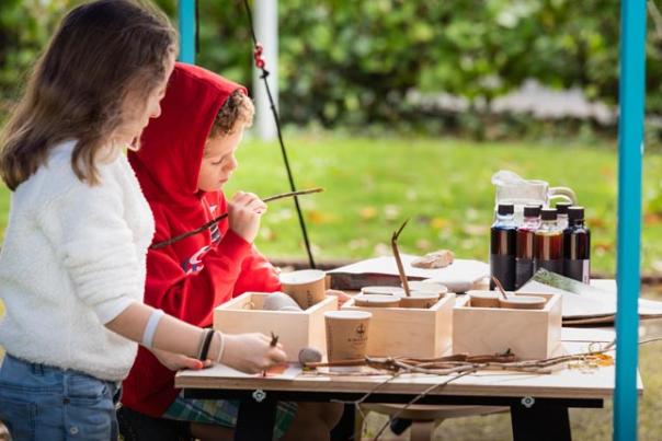 image shows children doing art and crafts