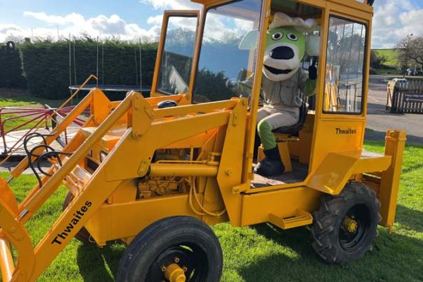 mascot in a tractor