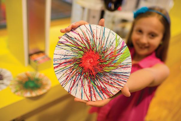 A child displays artwork at Crayola Experience in Easton, Pa.