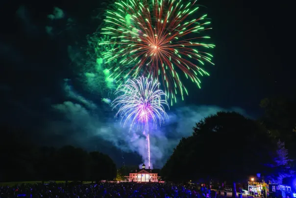 A bright and beautiful fireworks show takes place over the historic buildings of American Village in Montevallo.