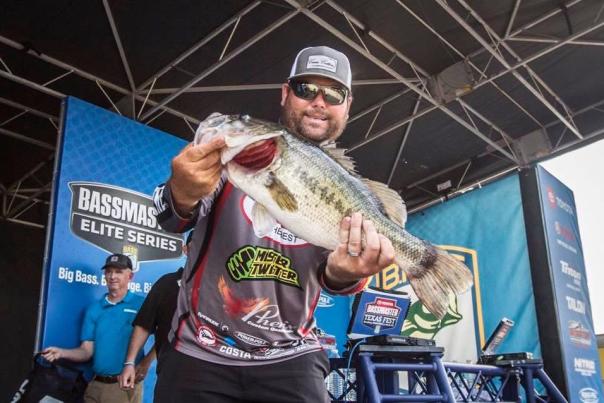 Clent Davis poses with a bass fish at a pro angling event.