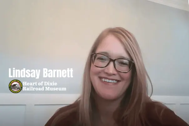 Lindsay Barnett smiles in her home for a video about the Heart of Dixie Railroad Museum.