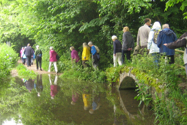 Walkers cross a little bridge in Dorchester