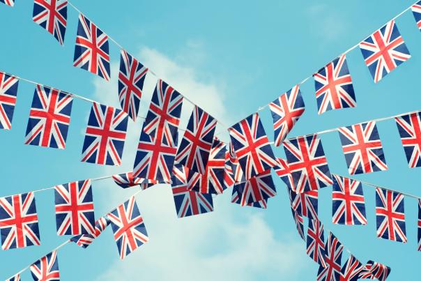 Union flag bunting with blue sky and white clouds in the background