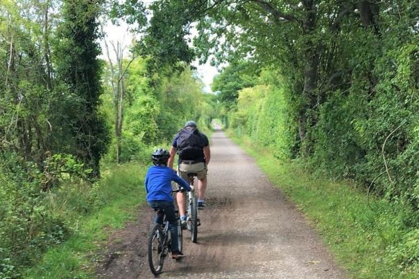 A man and boy cycling on the North Dorset Trailway