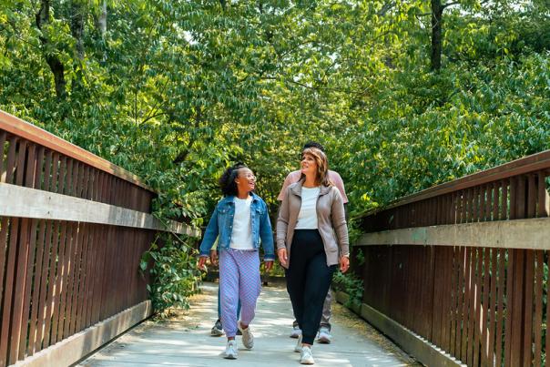 A family walking on a bridge.