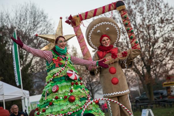 People dressed as a Christmas tree and Gingerbread man at the Tree Lighting Ceremony.