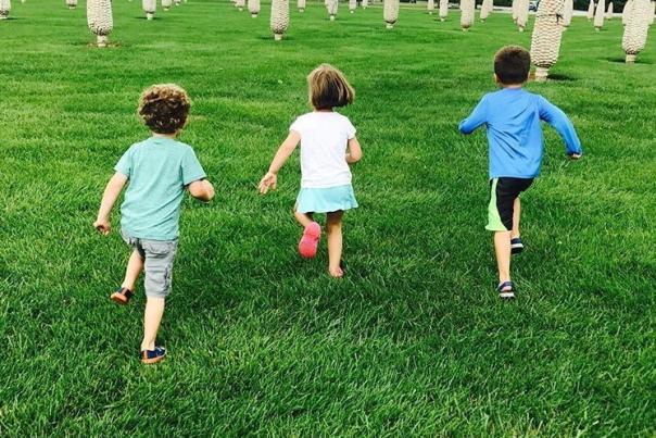 Kids running through the field of corn