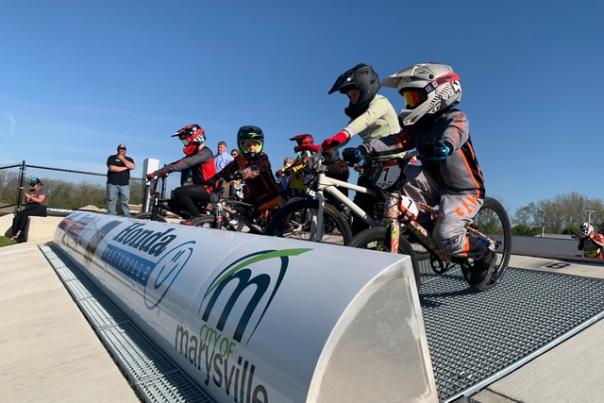 BMX riders waiting at a gate to compete