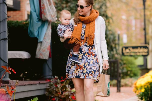 Woman carrying her baby down the leave covered streets in Historic Dublin